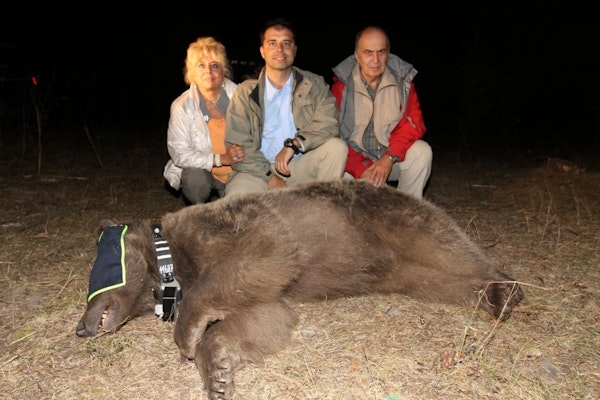 Cagan (centre) with his Mother, Father and a sedated bear fitted with a crittercam