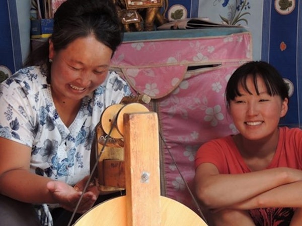 Community members in Tost spinning wool for Snow Leopard Enterprises products