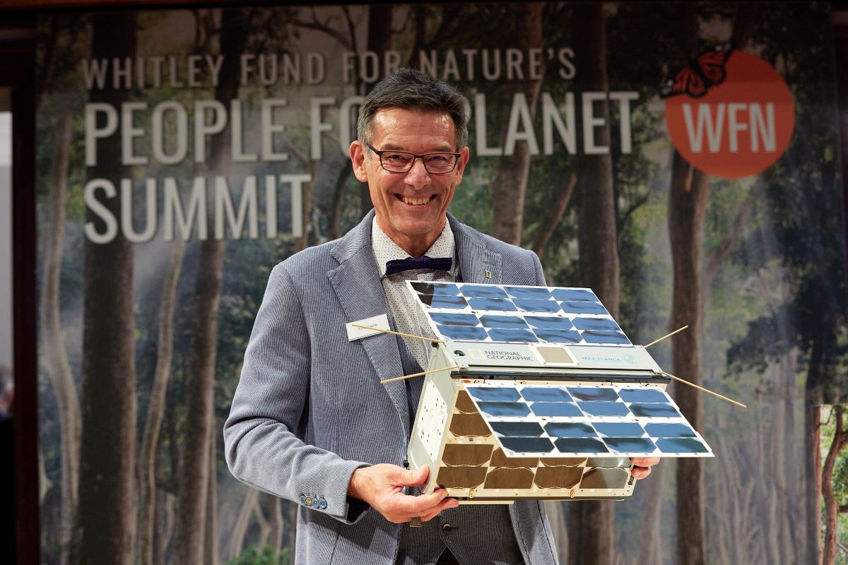 Martin Wikelski with model satellite, People for Planet Summit